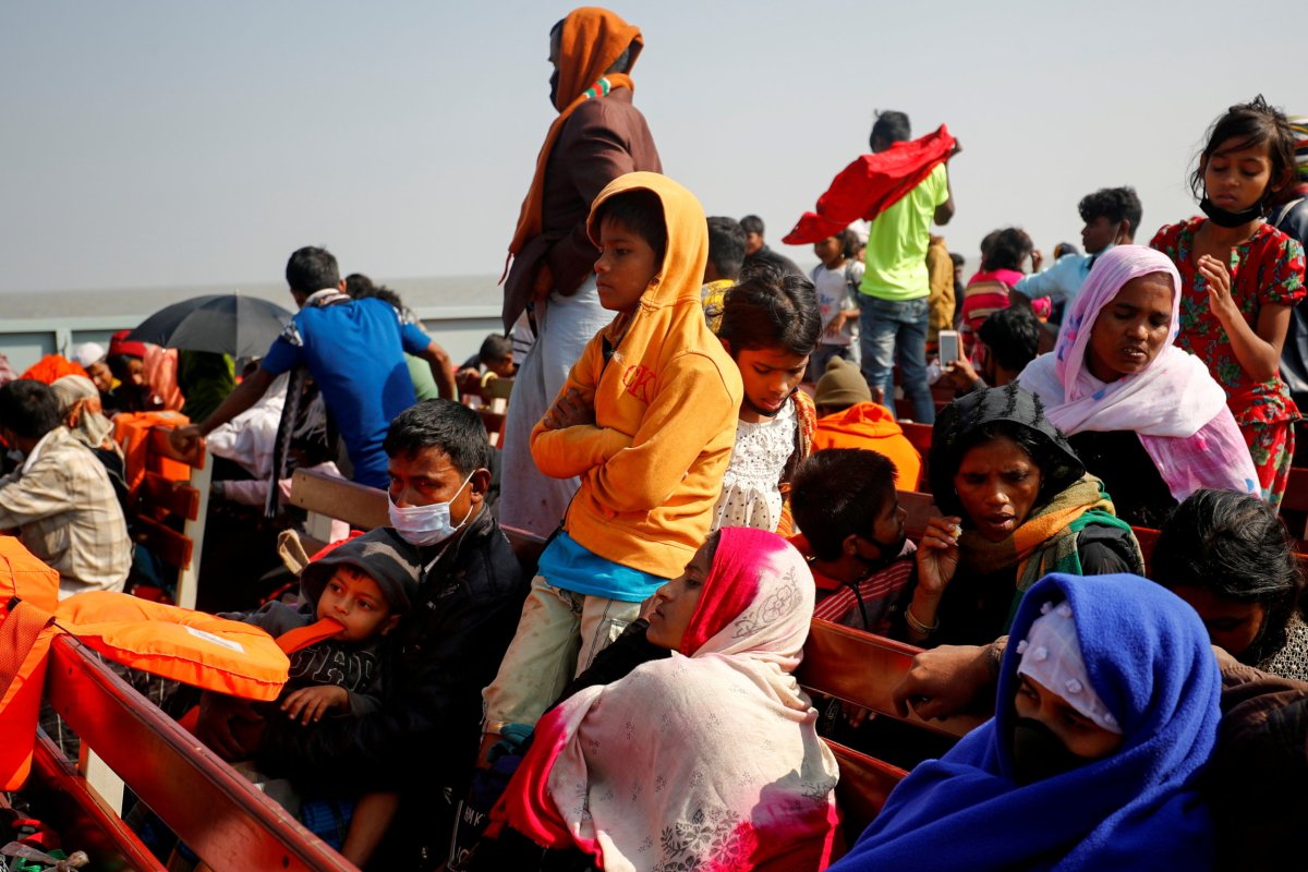 FILE PHOTO: Rohingya refugees sit on wooden benches of a navy vessel on their way to the Bhasan Char island in Noakhali district