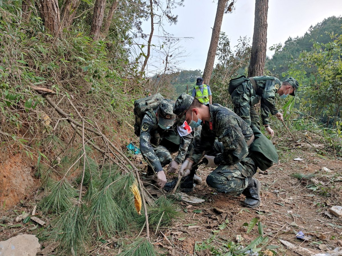 Paramilitary police officers work at the site where a China Eastern Airlines Boeing 737-800 plane crashed, in Wuzhou