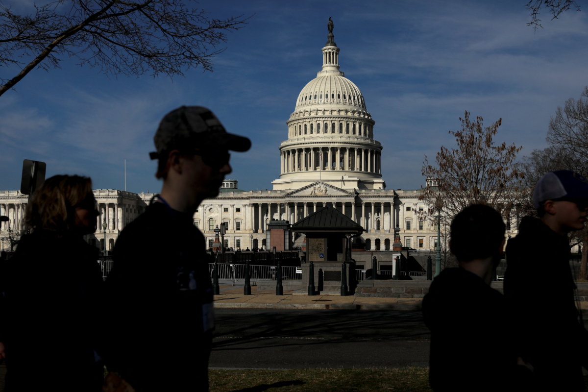 FILE PHOTO: Pedestrians walk by the United States Capitol building in Washington