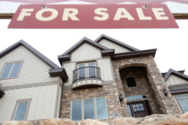 FILE PHOTO: A newly built home sits vacant with a “For Sale” sign in front, at the Courtland Ridge development in Alpine, Utah