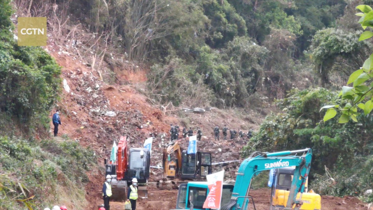 Rescuers work at the plane crash site in Wuzhou