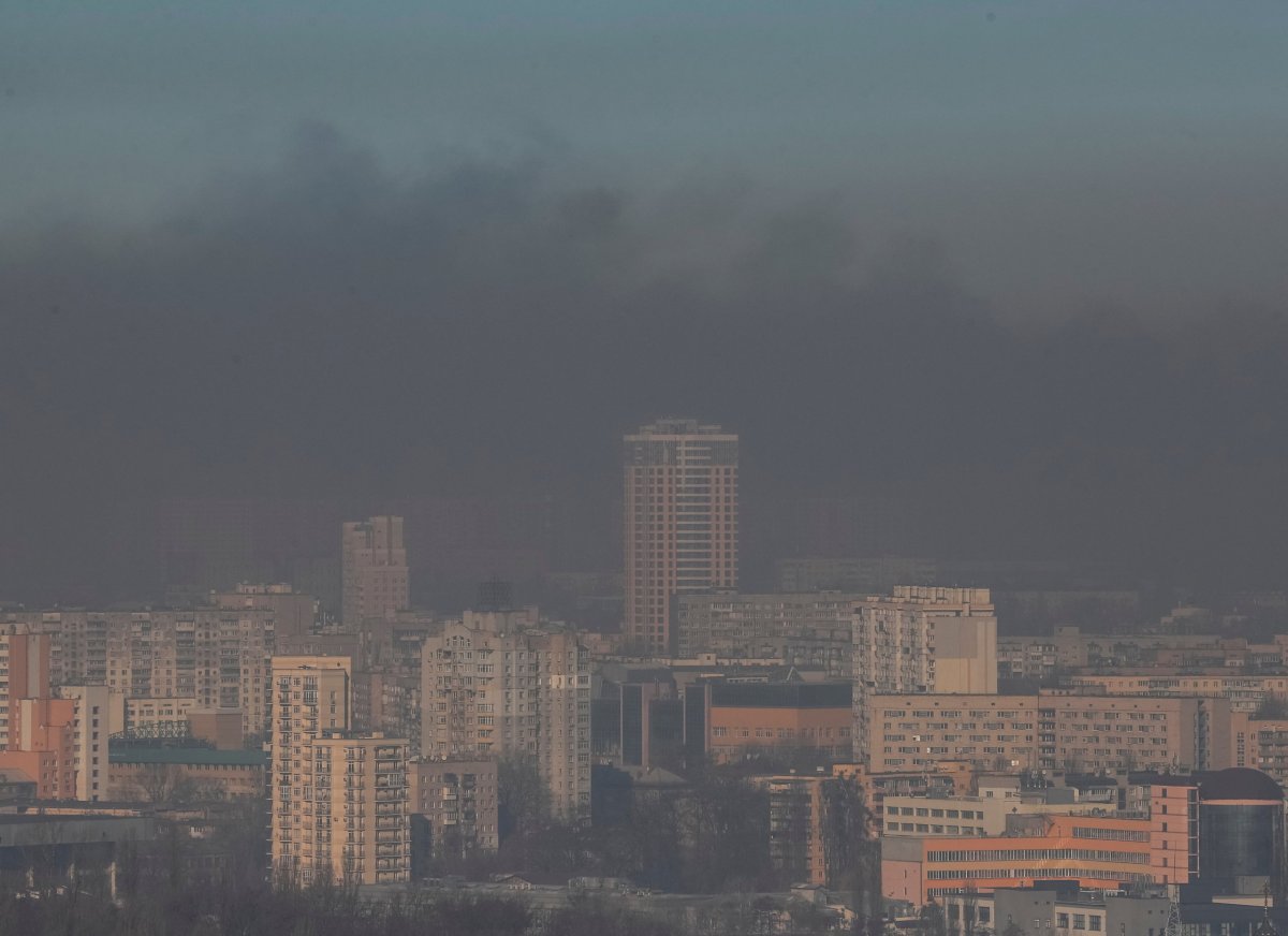 Residential buildings in Kyiv are seen through smoke from fires after shelling nearby