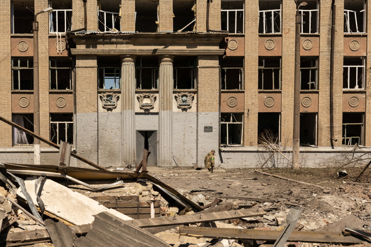 A Ukrainian soldier walks in front of a school that was bombed amid Russia’s invasion in Ukraine, in Kostyantynivka, in the Donetsk region