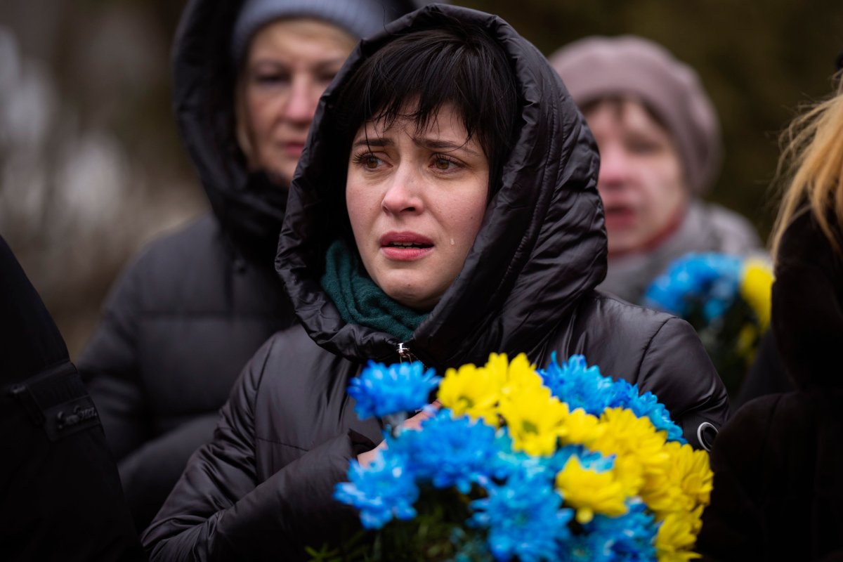 A woman cries during a memorial service to mark the one-year anniversary of the start of the Russia Ukraine war