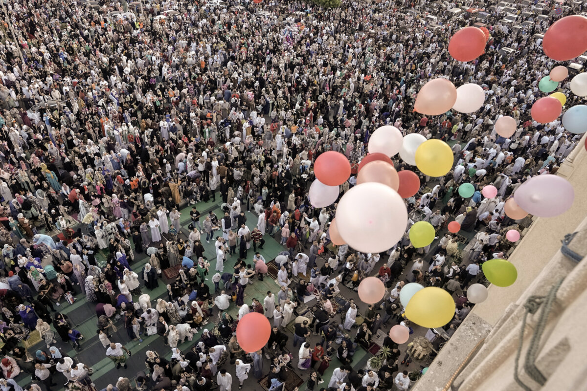 Balloons are distributed for free after Eid al-Fitr prayers, marking the end of the Muslim holy fasting month of Ramadan outside al-Seddik mosque in Cairo, Egypt,