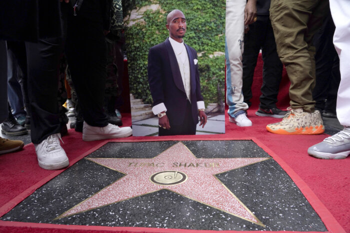 An image of the late rapper/actor Tupac Shakur appears near his new star on the Hollywood Walk of Fame