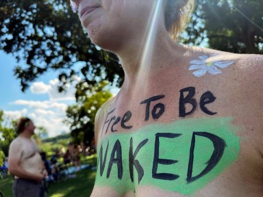A rider poses at the start of the Philly Naked Bike Ride in Philadelphia, Saturday, Aug. 26, 2023.