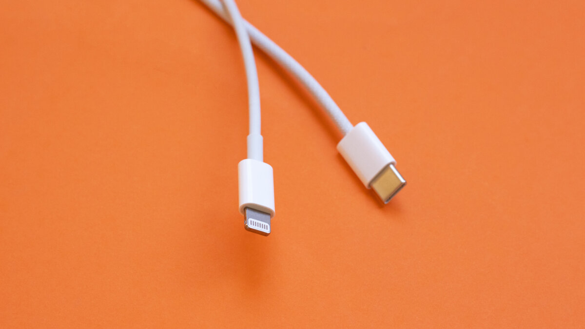USB type C port cable for charging to the smartphone on orange background. EU law to force USB-C chargers.